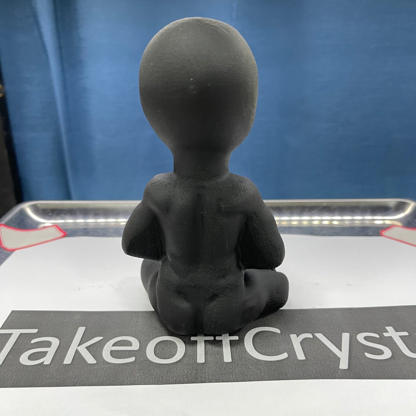 Obsidian sitting Alien carving