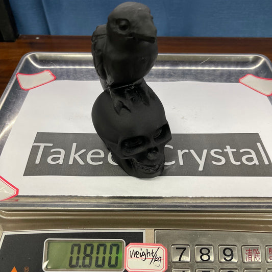 Crow skull obsidian carving
